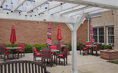 Outdoor patio area with red umbrellas and furniture