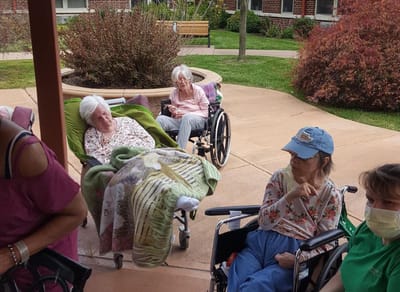 Residents relaxing outdoors in wheelchairs