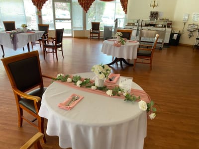 Dining area with elegantly set tables and floral decorations