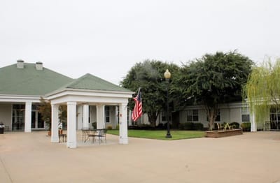 Exterior view of assisted living facility with American flag