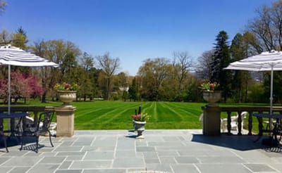 Outdoor patio area with seating and gardens