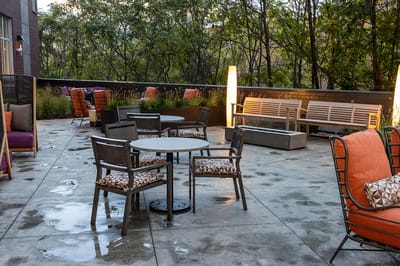 Outdoor patio space with seating and greenery