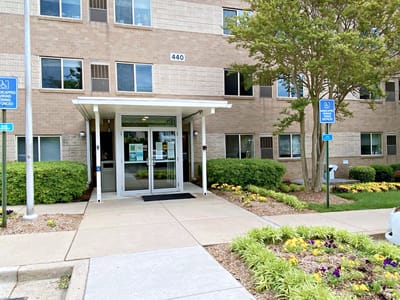 Entrance of University Gardens facility with landscaping