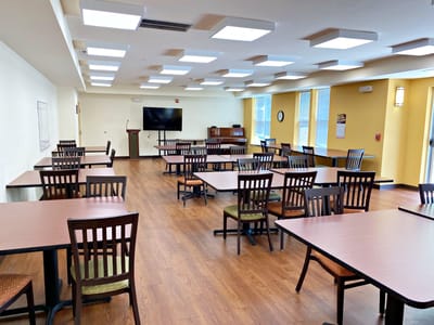 Interior view of a dining room with tables and chairs