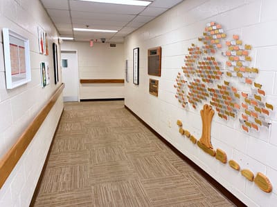 A hallway in the facility featuring a decorative tree wall.