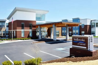 Exterior view of Wellbrooke of Carmel facility with signage