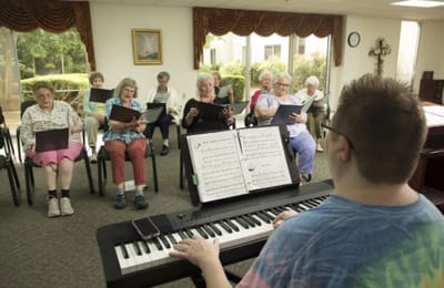 Residents participating in a music activity in a common area