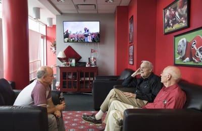 Residents enjoying a conversation in a cozy lounge area