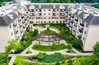 Aerial view of a senior living facility with gardens
