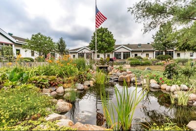 Beautiful landscaped outdoor area with pond and flag