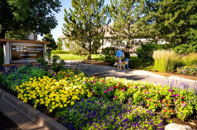 Residents enjoying a walk surrounded by colorful flowers
