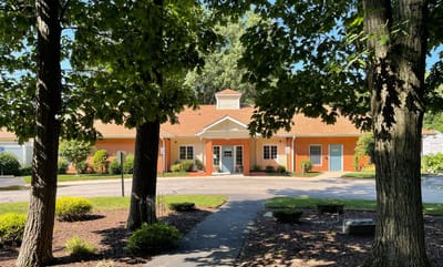 Exterior view of the Hope Alzheimer's Center surrounded by trees