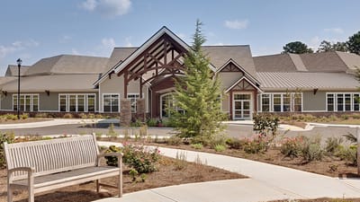 Exterior view of a senior living facility with landscaping