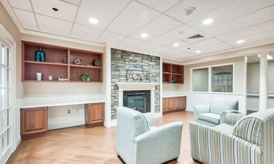 Bright common area with comfortable seating and a fireplace