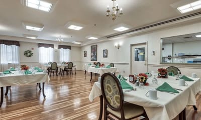 Dining area set for a meal with flowers and utensils