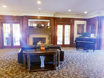 Lounge area with piano and fireplace