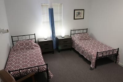 Cozy shared resident room with twin beds and lamps