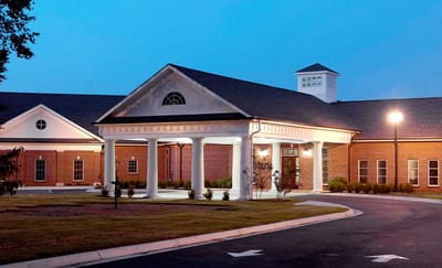 Exterior view of a senior care facility at dusk