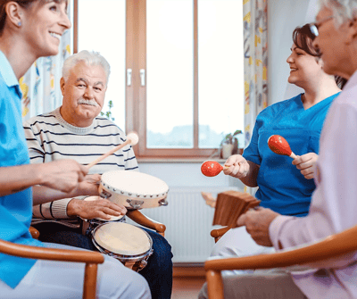 Residents and staff engaged in a music activity.