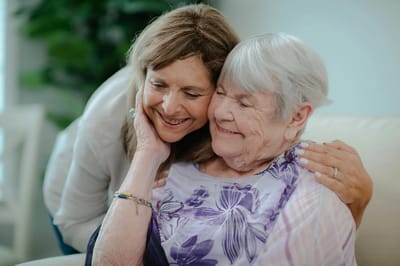Caregiver and resident enjoying a warm moment together