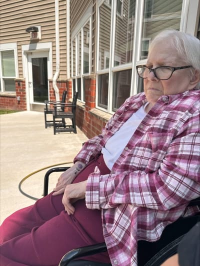 Resident enjoying the outdoor space in a wheelchair.
