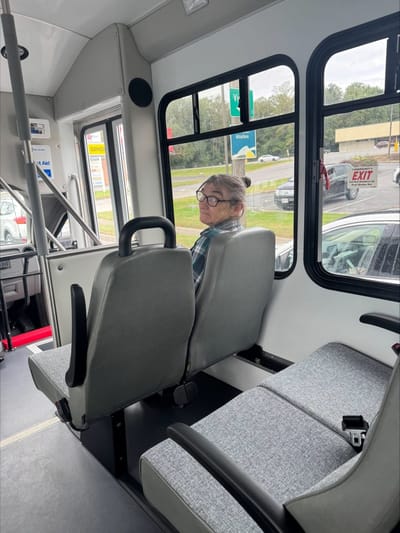 Senior rider on a facility transport bus