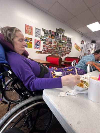 Resident enjoying a meal in the dining area