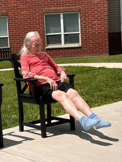 Senior woman relaxing outdoors in a chair