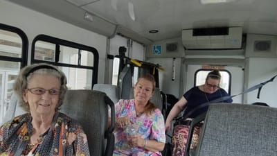 Residents traveling in a facility van