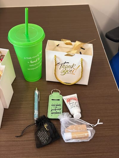 Gift items and a drink cup on a table