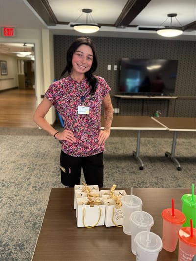 Staff member with food items in a common area.