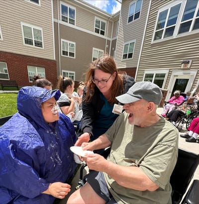 Resident enjoying an outdoor activity with staff