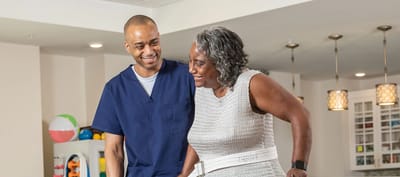 Caregiver assisting a resident in a common area