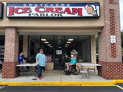 Residents and staff outside an ice cream parlor