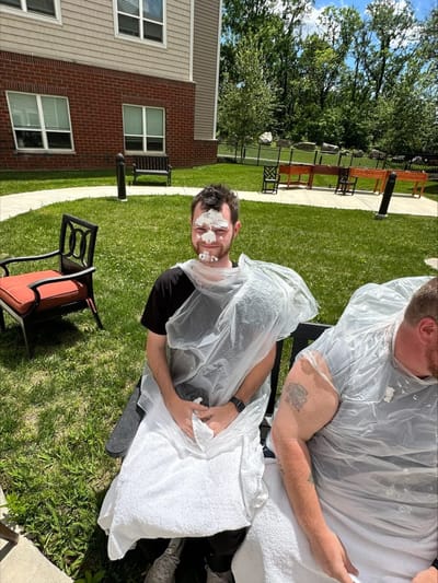 Residents enjoying an outdoor activity with foam.