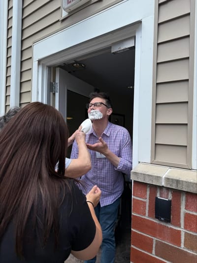 Residents playfully enjoying a cream pie face moment.