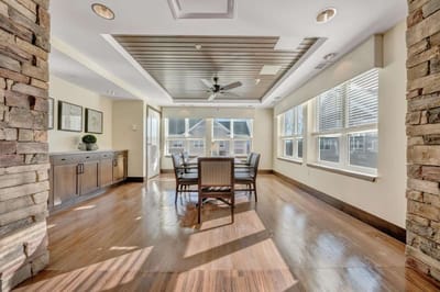 Bright common area with tables and chairs.
