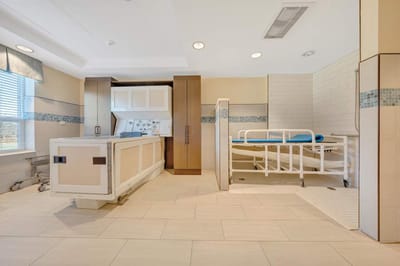 Interior view of a patient room with hospital bed.