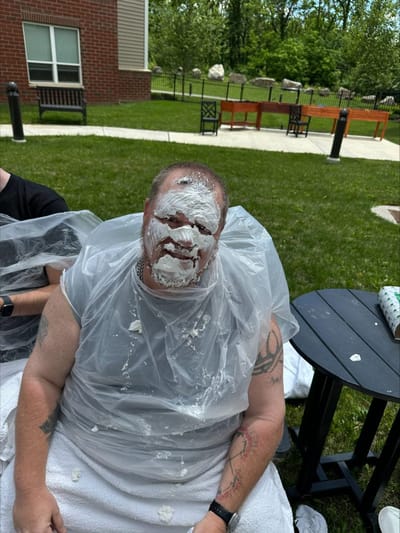 Resident participating in a playful outdoor activity.