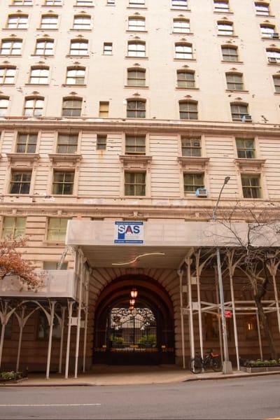 Facade of a large building with an entrance archway