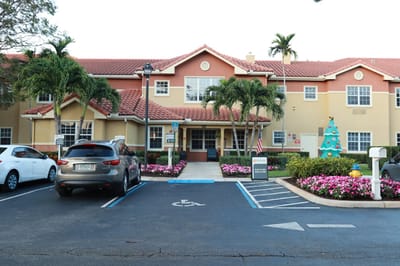 Front exterior of Sonata Coconut Creek with gardens