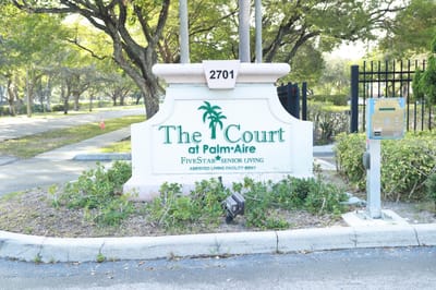 Entrance sign of The Court at Palm Aire facility