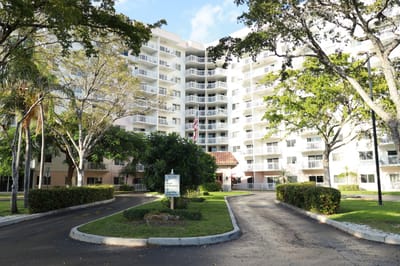Exterior view of a senior living facility with gardens
