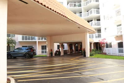 Covered entrance of a senior living facility with parking