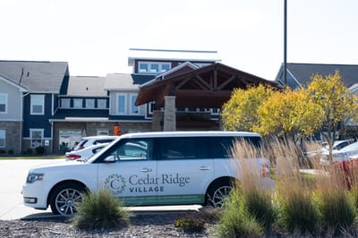 Exterior view of Cedar Ridge Village with facility van