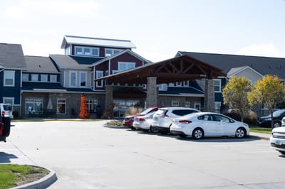 Entrance of a senior living facility with parking area