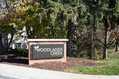 Exterior sign of Woodlands Creek Senior Living