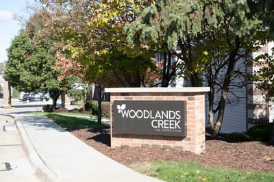 Woodlands Creek Senior Living sign at the entrance