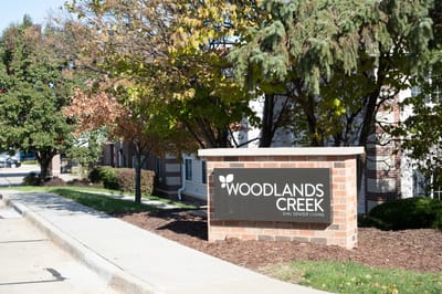 Exterior view of Woodlands Creek Senior Living sign