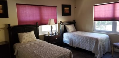 Bright resident room with twin beds and window